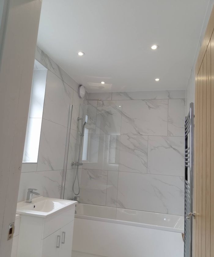 Marble-effect bathroom with ceiling downlights