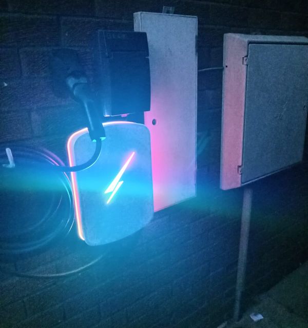 EV charger lit up at night