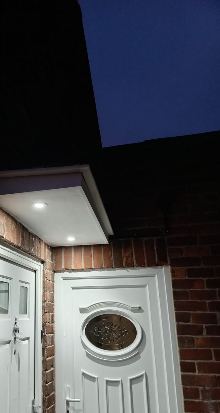 Porch at night lit by downlights in the canopy