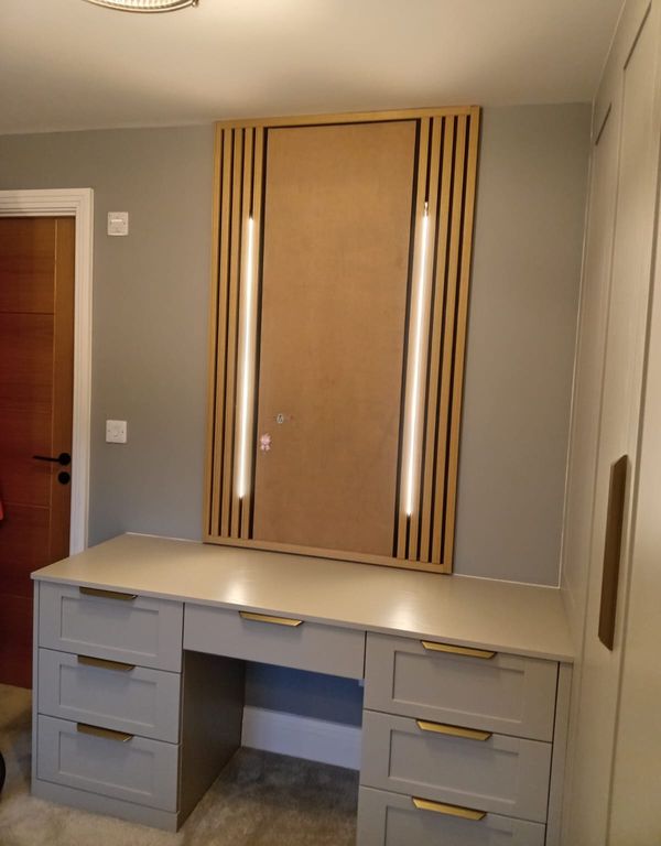 Dressing table with LED strips set into a slatted timber panel